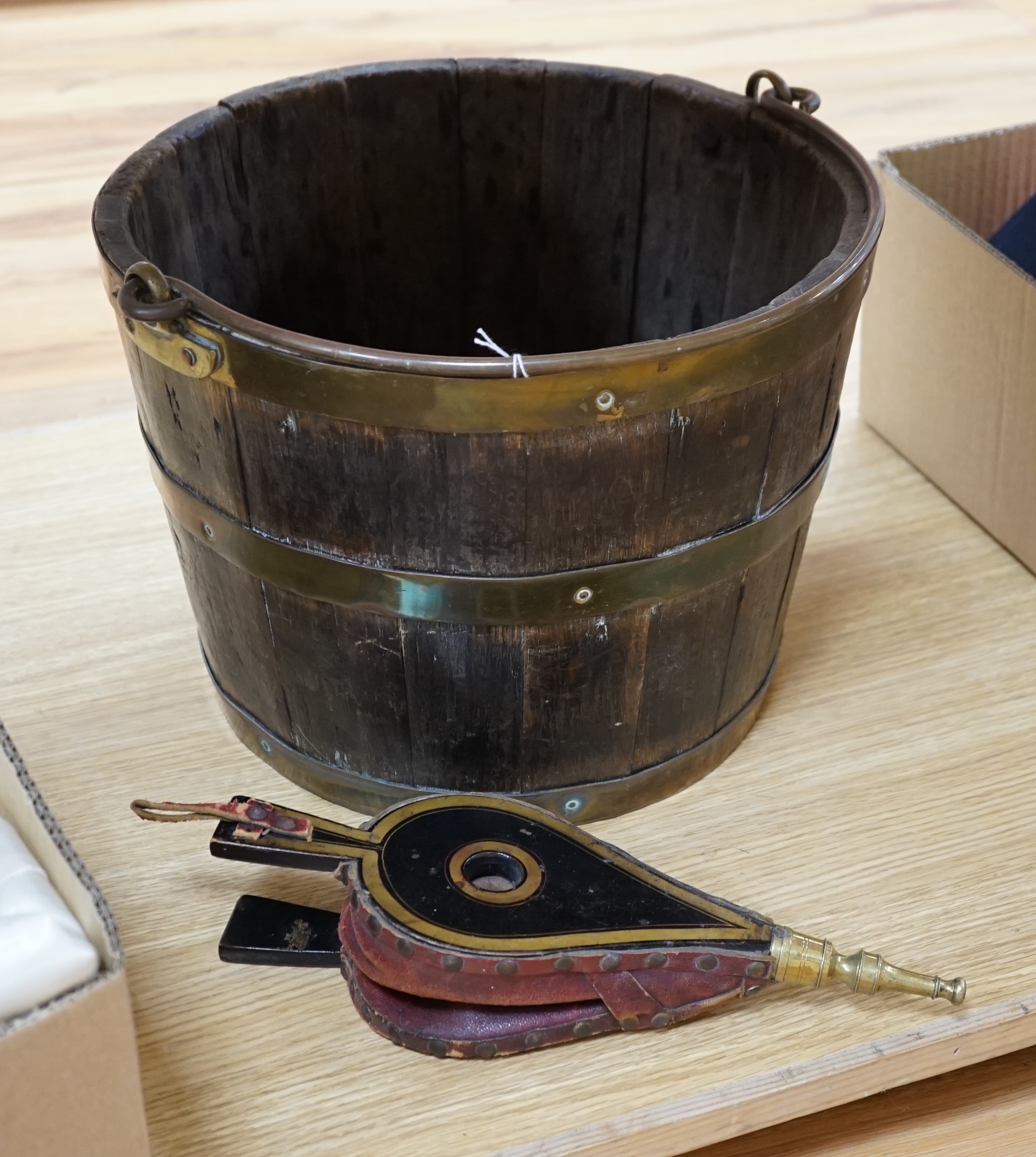 A coopered brass bound oak bucket and a small pair of lacquered bellows